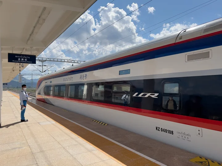 Train in train station with clouds