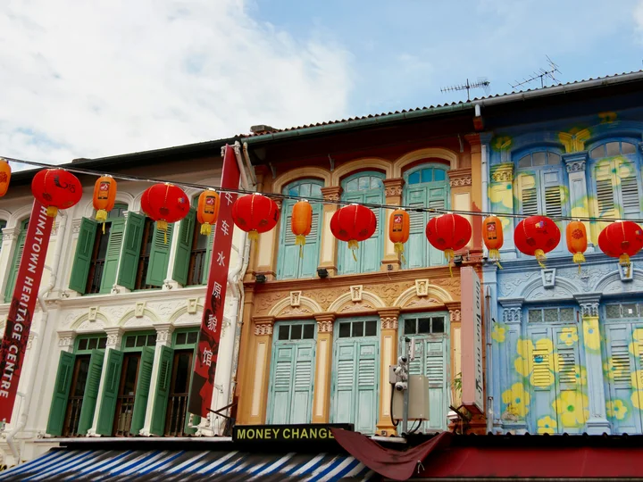 Colourful Singapore buildings with red lanterns strung across