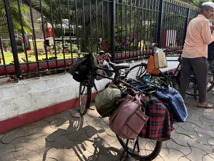 bike loaded up with lunchboxes to deliver in Mumbai