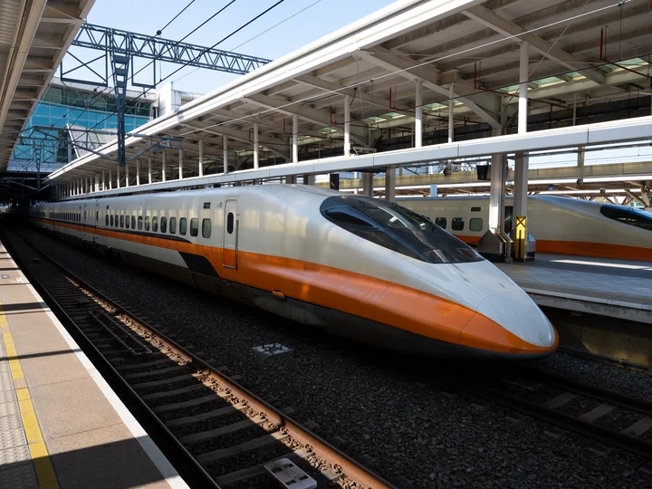 Taiwan Kaohsiung Liuhe Night Market at a station, orange and white painted train