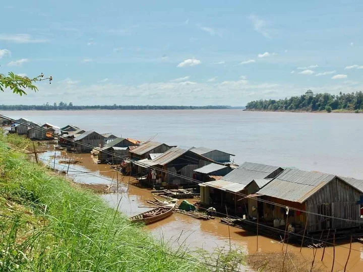 A floating Vietnamese village is anchored to the island by cables.