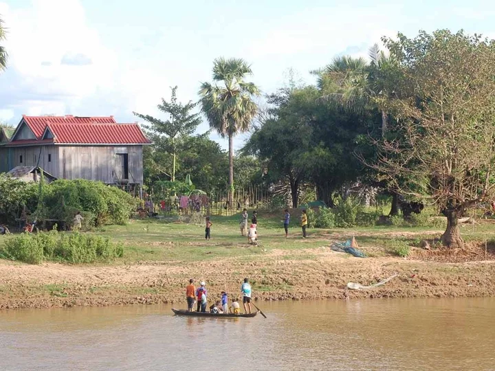 These boys cross the river for a game of footy with their mates on the other side.