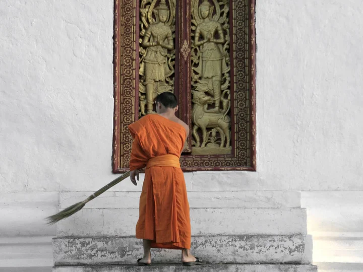 Laos- monk sweeping