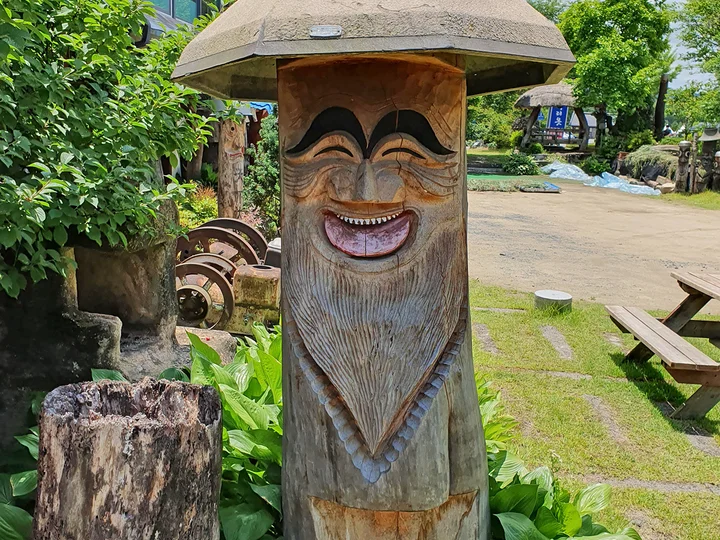 A traditional wooden sculpture with a smile in South Korea, called a Jangseung