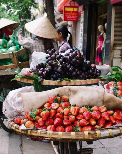 Fresh produce balanced on the back of bicycles