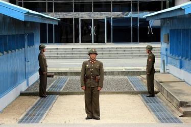 Three soldiers standing guard at the DMZ in Korea 