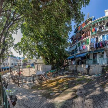 Colourful buildings with washing hanging and bicycle propped up outside 