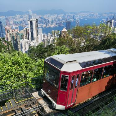 Red tram climbing up hillside to Victoria Peak in Hong Kong 