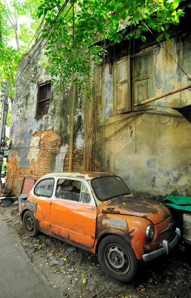 Orange vintage car street art on wall in Talad Noi, Bangkok 