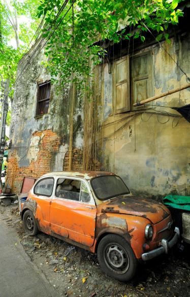 Orange vintage car street art on wall in Talad Noi, Bangkok 