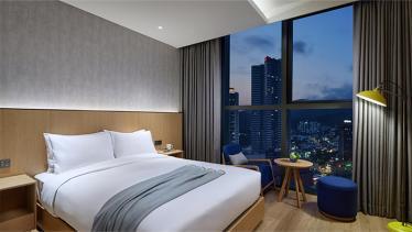 Standard Queen bedroom with city skyline view at L7 Haeundae hotel, Busan