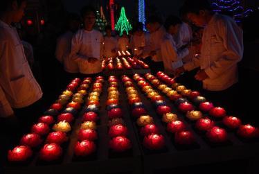 Praying by candlelight