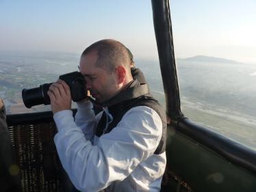 Man taking photograph in hot air balloon over Burma