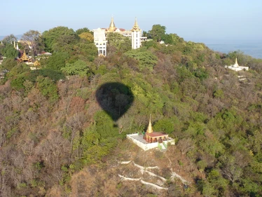 Hot air balloon shadow over the landscape in Burma