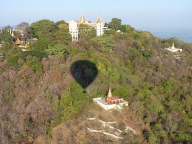 Hot air balloon shadow over the landscape in Burma