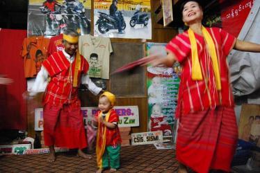 Lu Zaw performing with family members at the Moustache Brothers' home